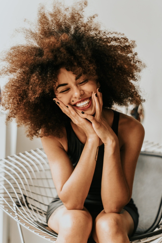 smiling curly-haired woman - edrs complete recovery program for eating disorder outpatient treatment